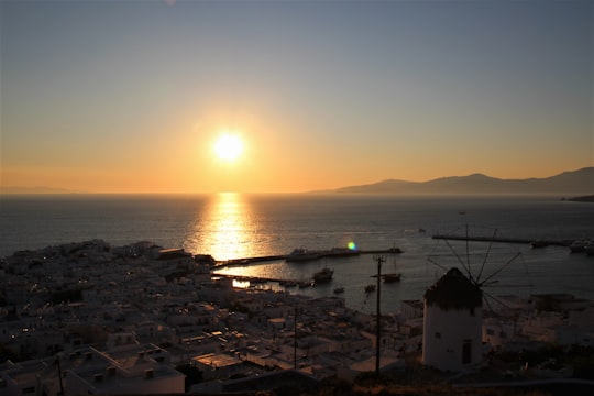 white and brown house near body of water during sunset in Mýkonos Greece