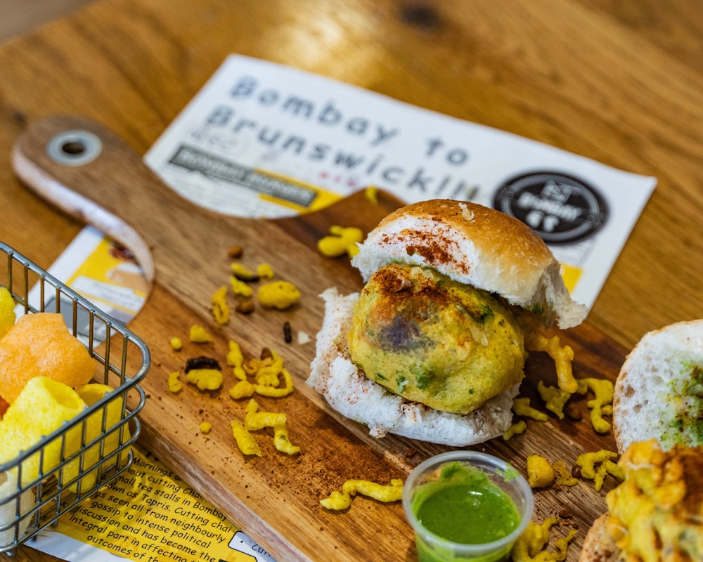 burger with lettuce and cheese on brown wooden chopping board