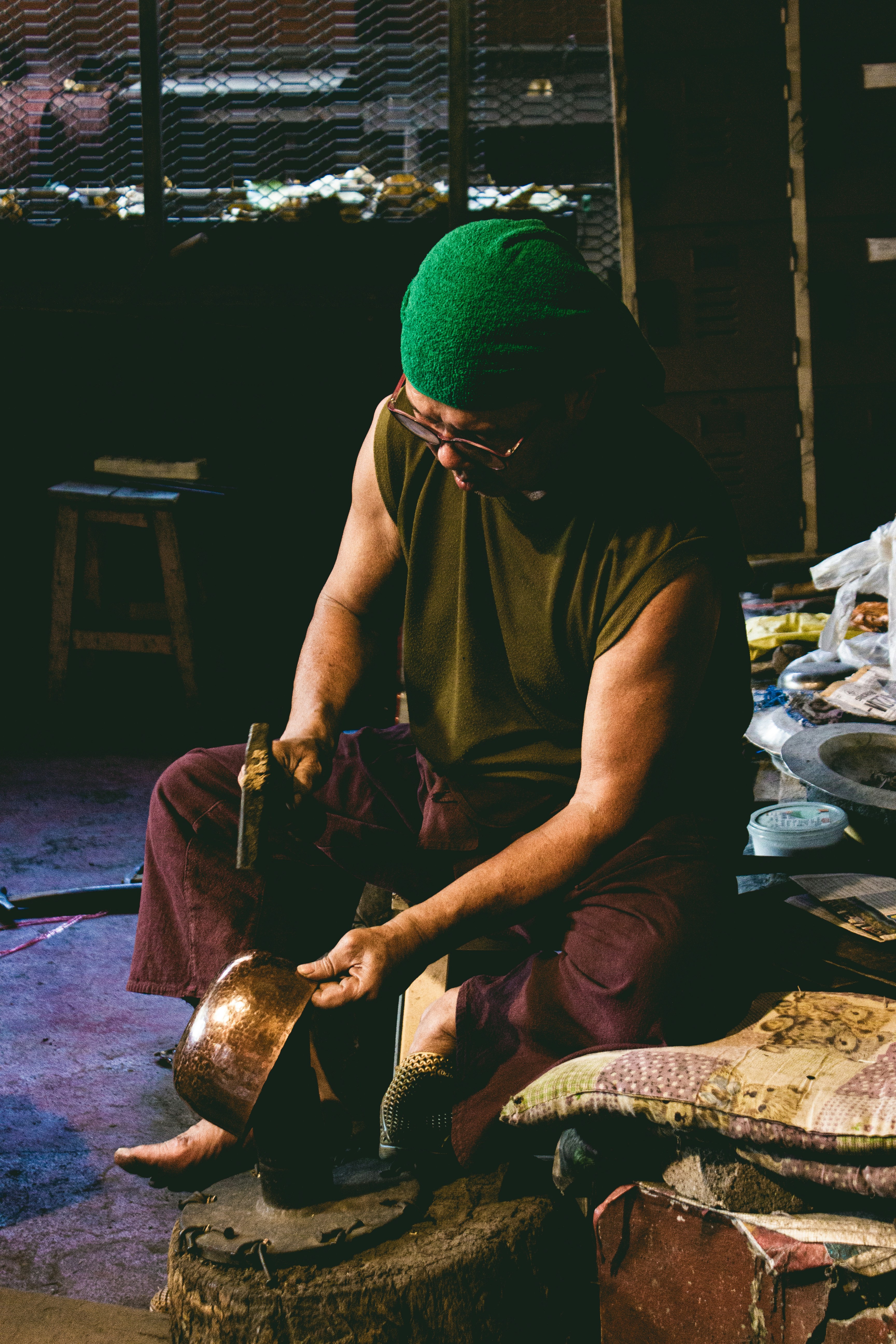 man in brown crew neck t-shirt and green knit cap sitting on floor