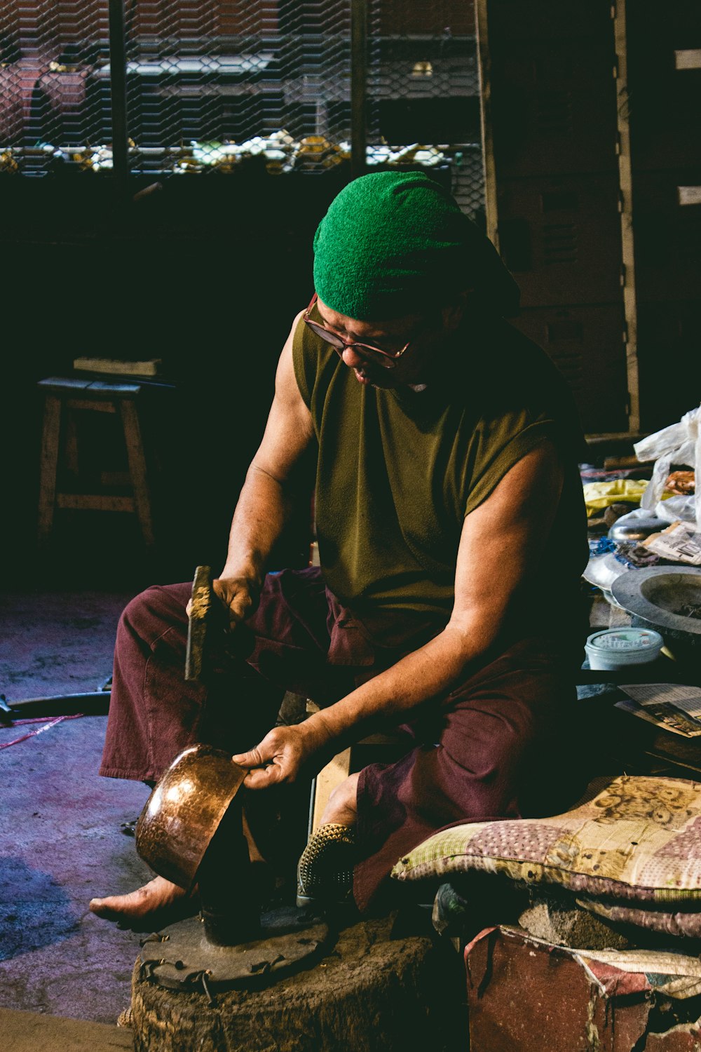 man in brown crew neck t-shirt and green knit cap sitting on floor