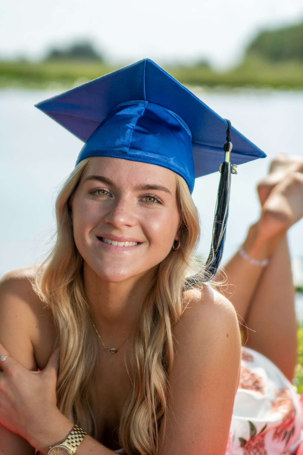 smiling woman wearing blue academic hat