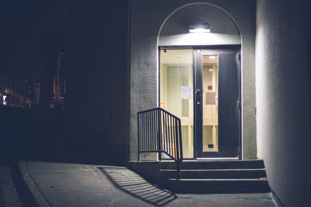 white wooden door in gray concrete building