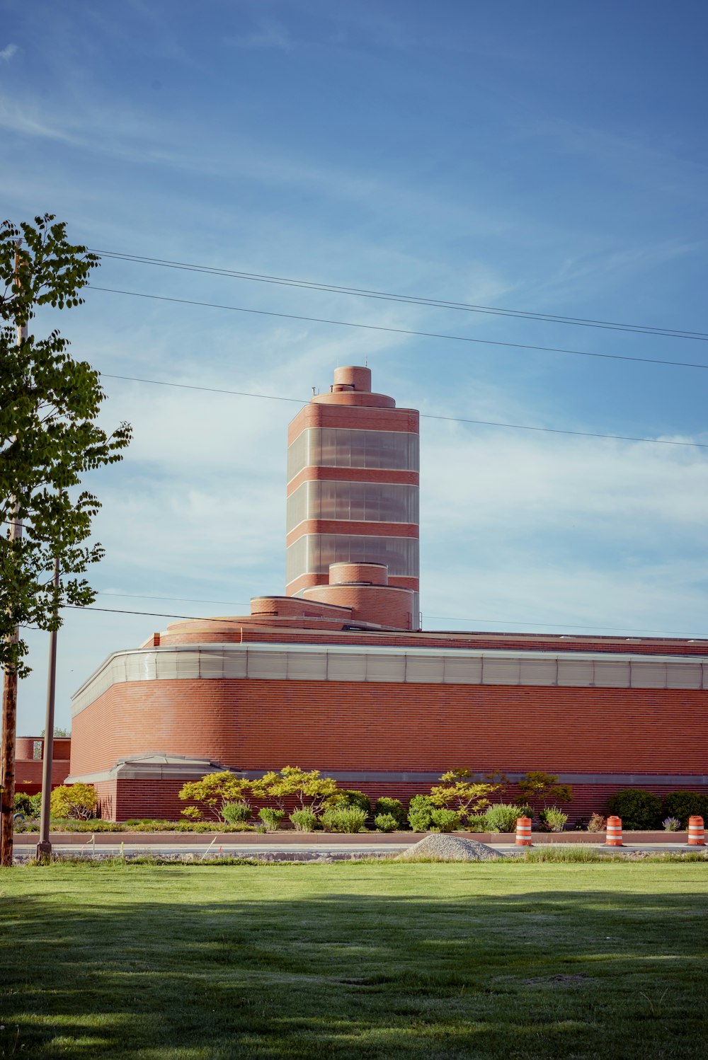 brown and white concrete building near green trees under blue sky during daytime