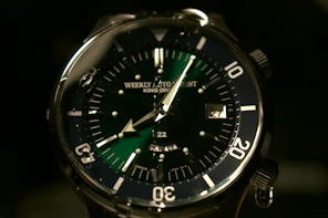 silver and black round analog watch