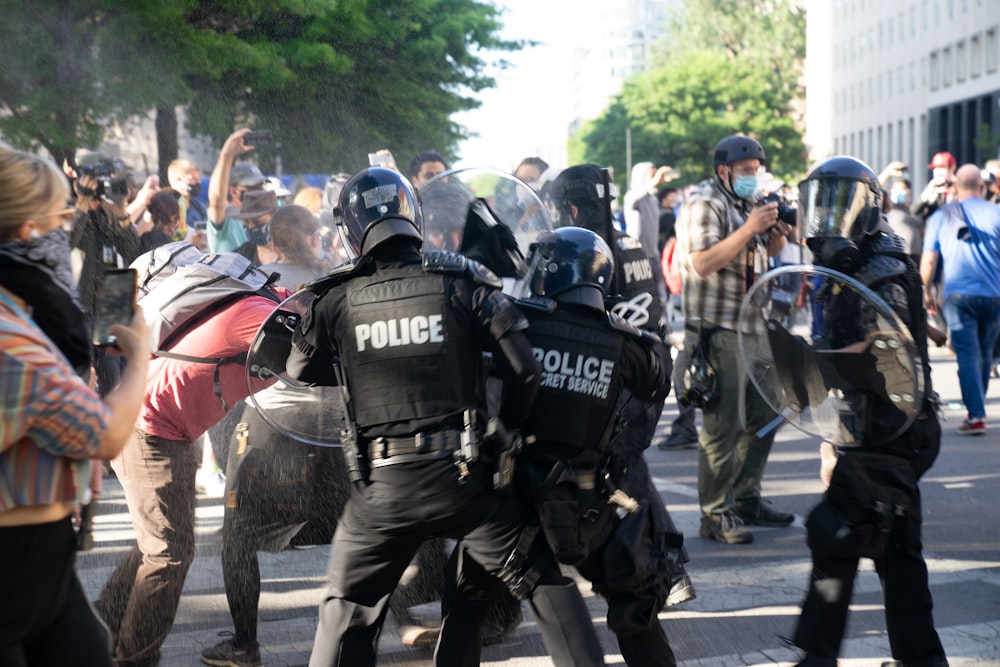 people in black police uniform riding on elephant during daytime