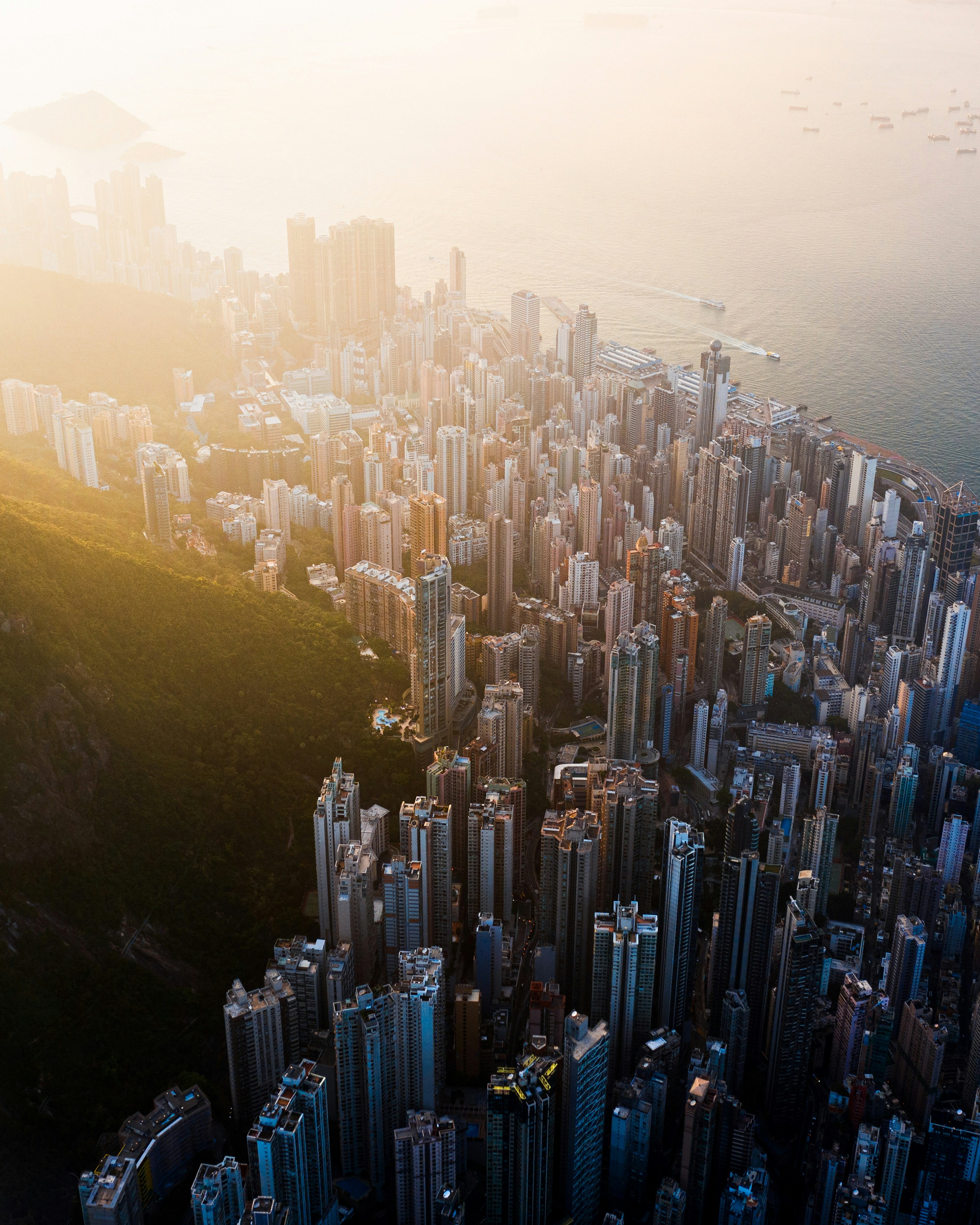 An aerial perspective of the high rises on Hong Kong Island during sunset.
