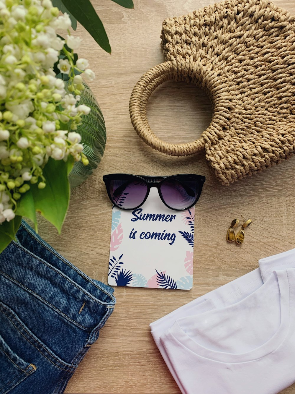 black sunglasses beside white and pink paper bag