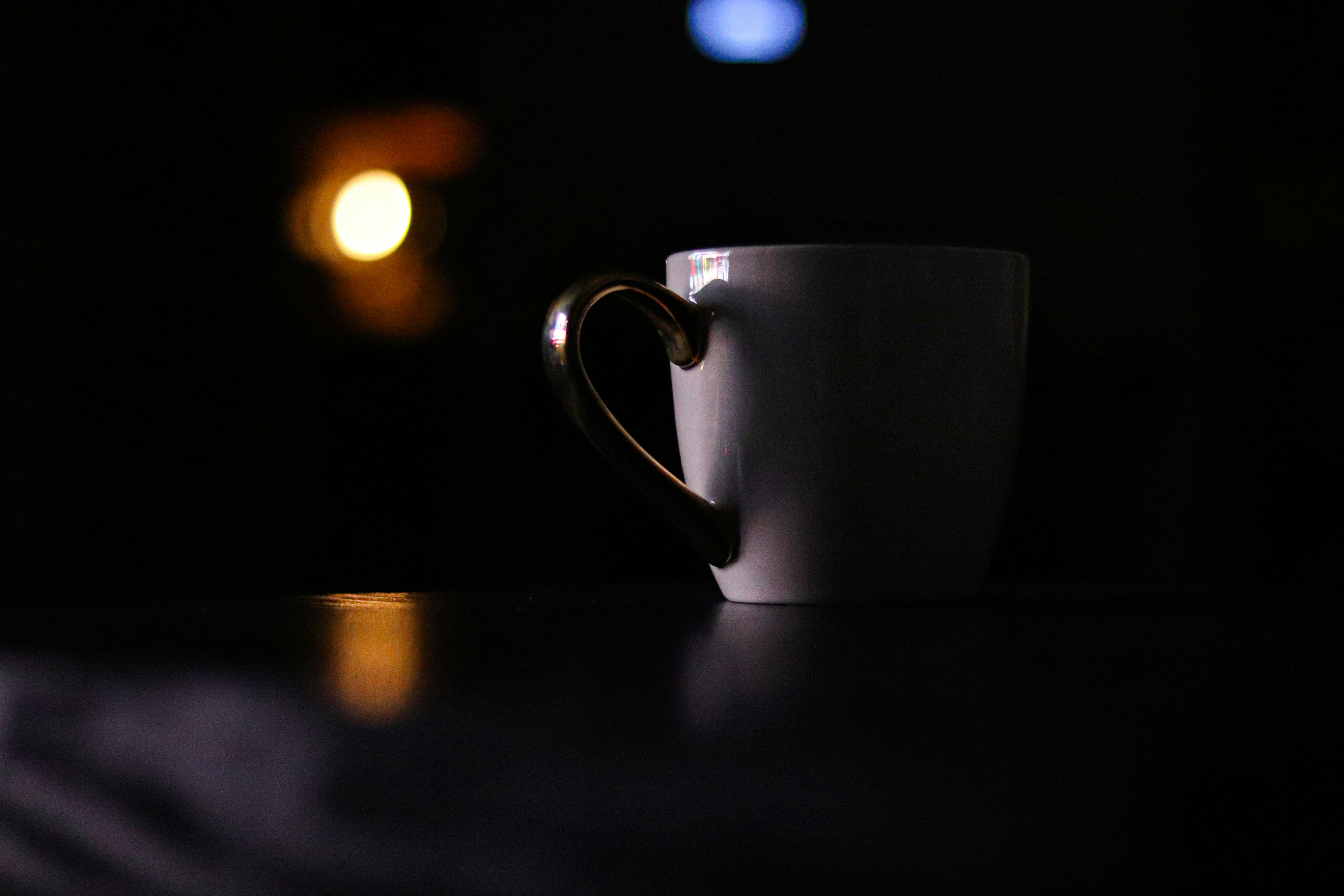 white ceramic mug on brown wooden table