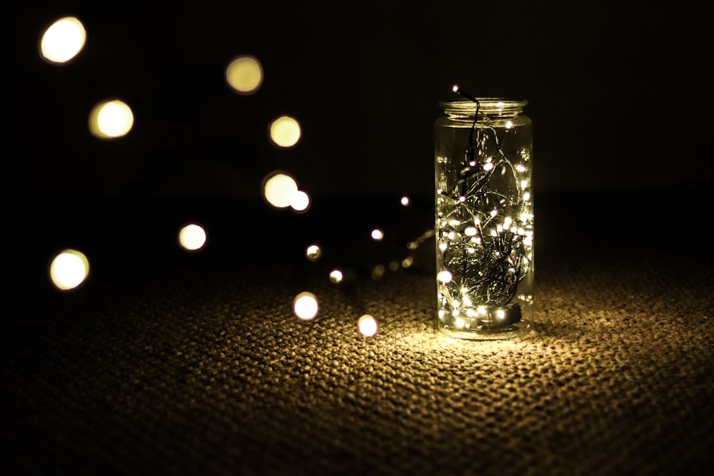 clear glass candle holder with string lights