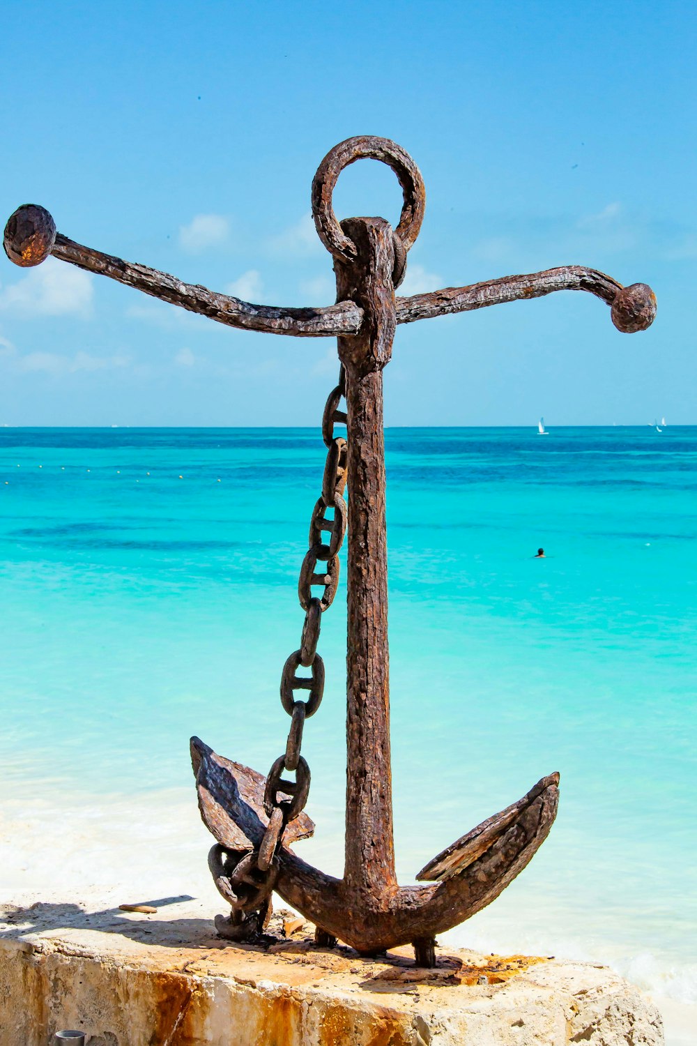 blue metal chain near sea during daytime