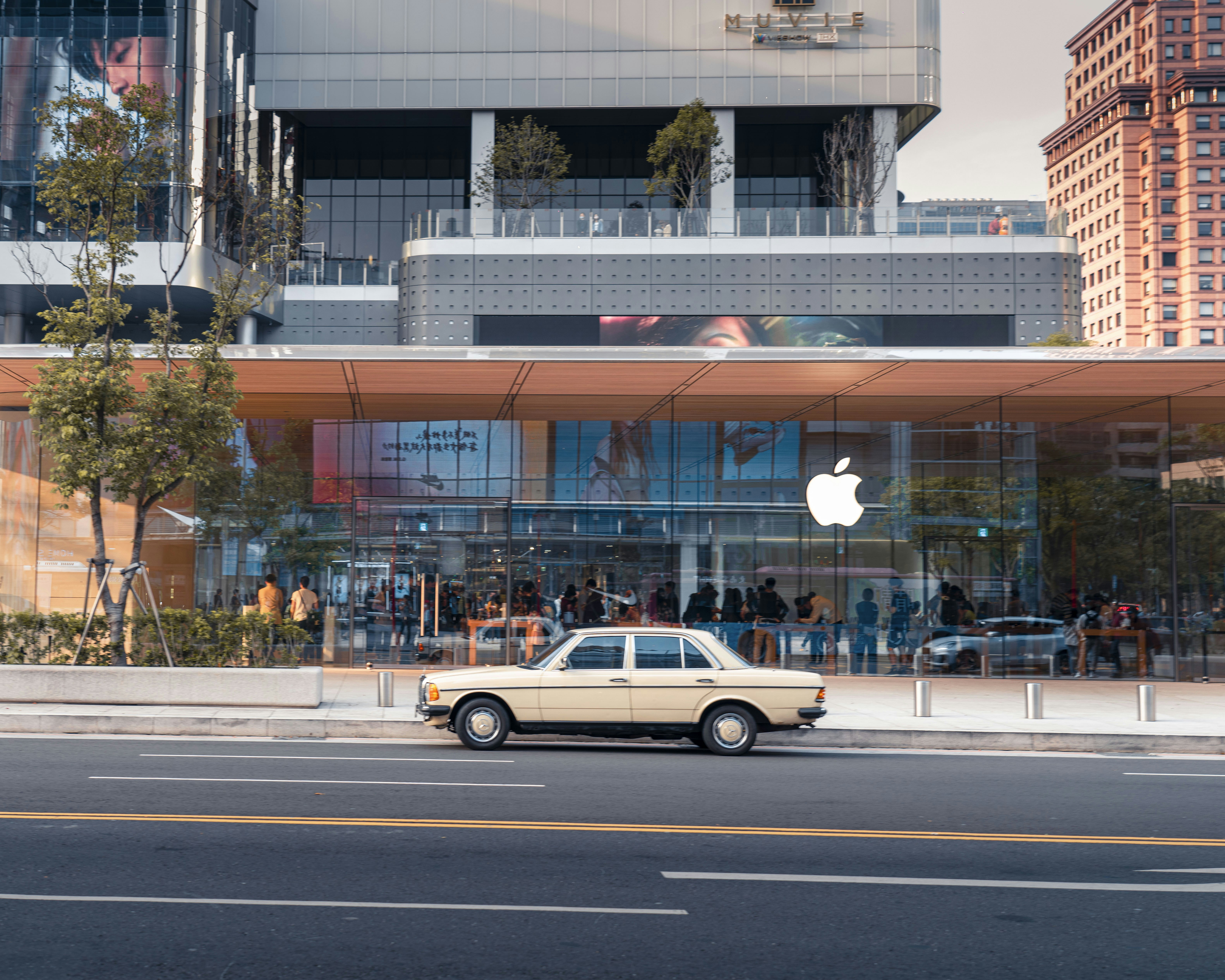 brown sedan on road near building during daytime