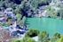 aerial view of houses near green trees and lake during daytime