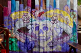 Finished mural featuring striking black and red colors with delicate skull motifs scattered throughout.