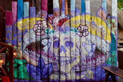 Finished mural featuring striking black and red colors with delicate skull motifs scattered throughout.