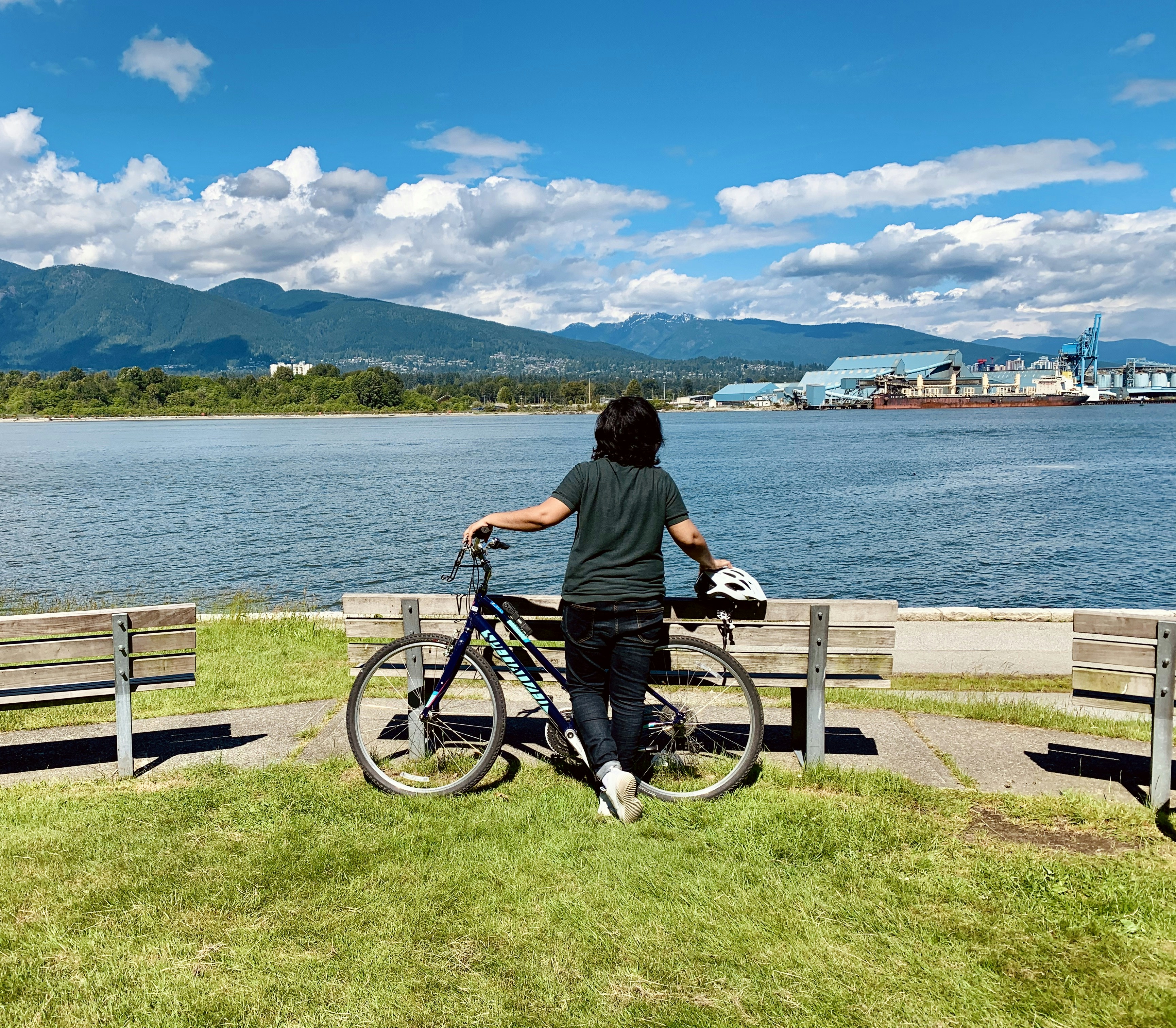 man in black shirt riding bicycle near body of water during daytime