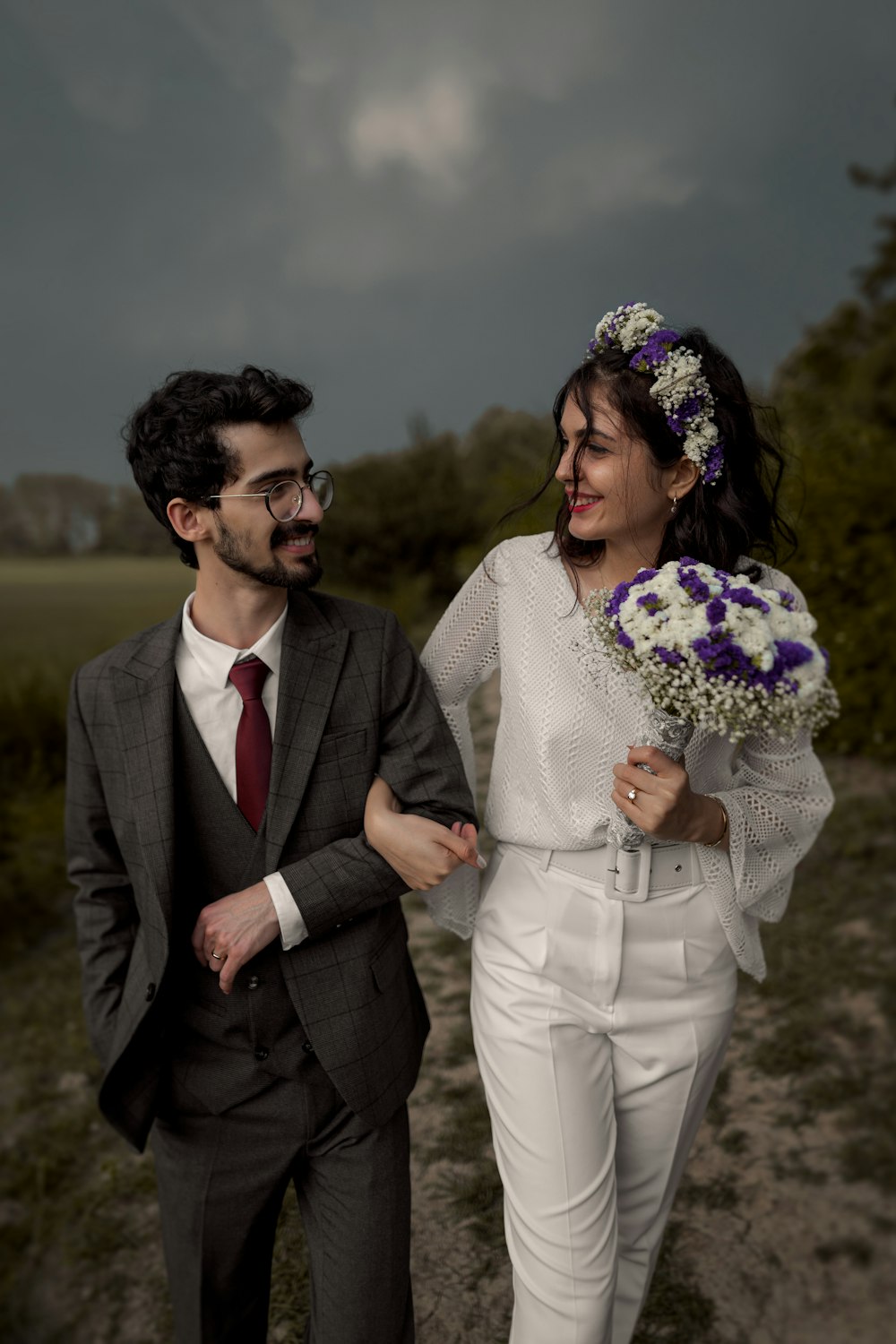 man in black suit jacket standing beside woman in white dress