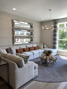 A modern living room showcasing a sleek, handcrafted sofa with warm wooden accents.