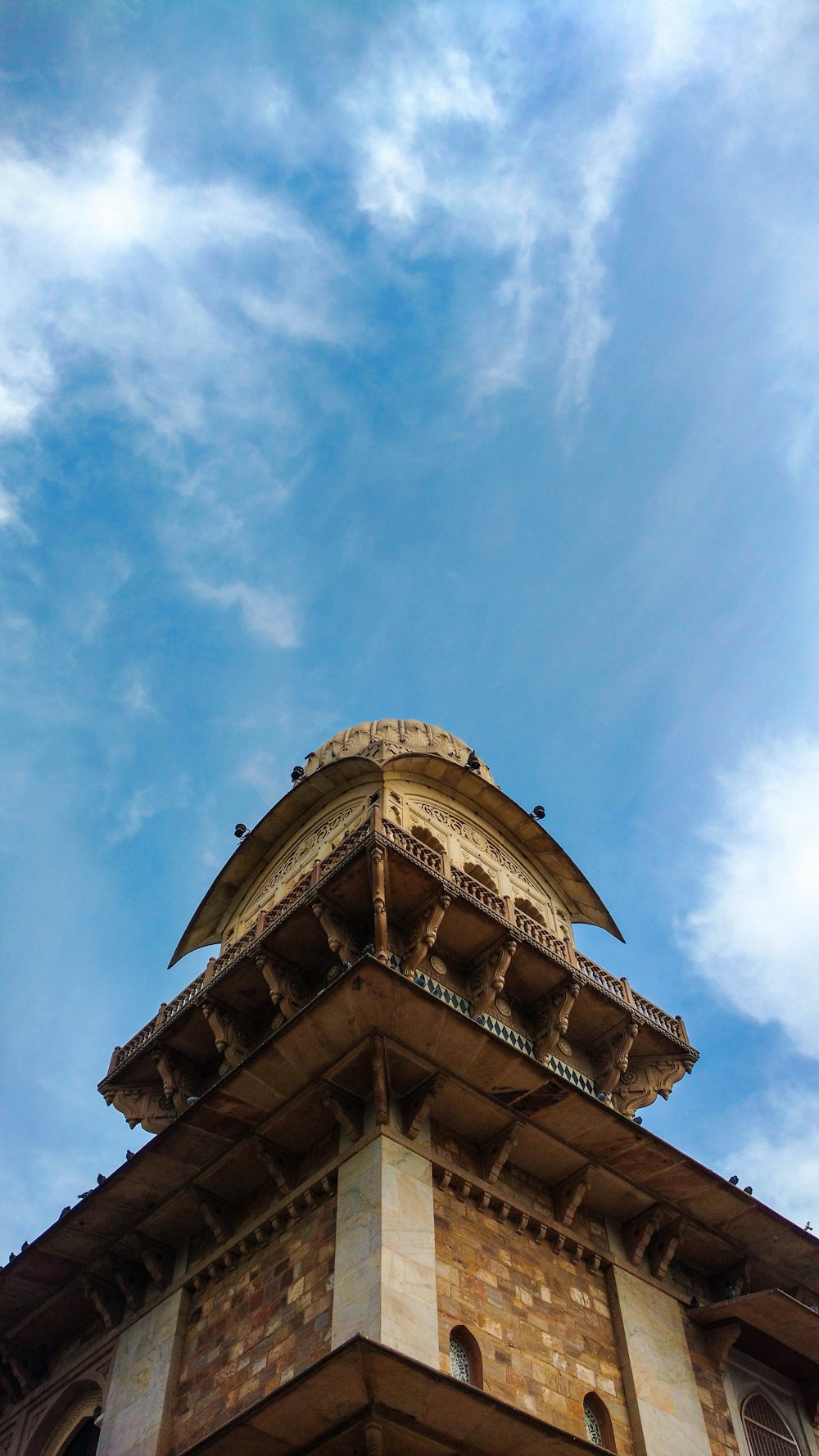 gold and white concrete building under blue sky during daytime