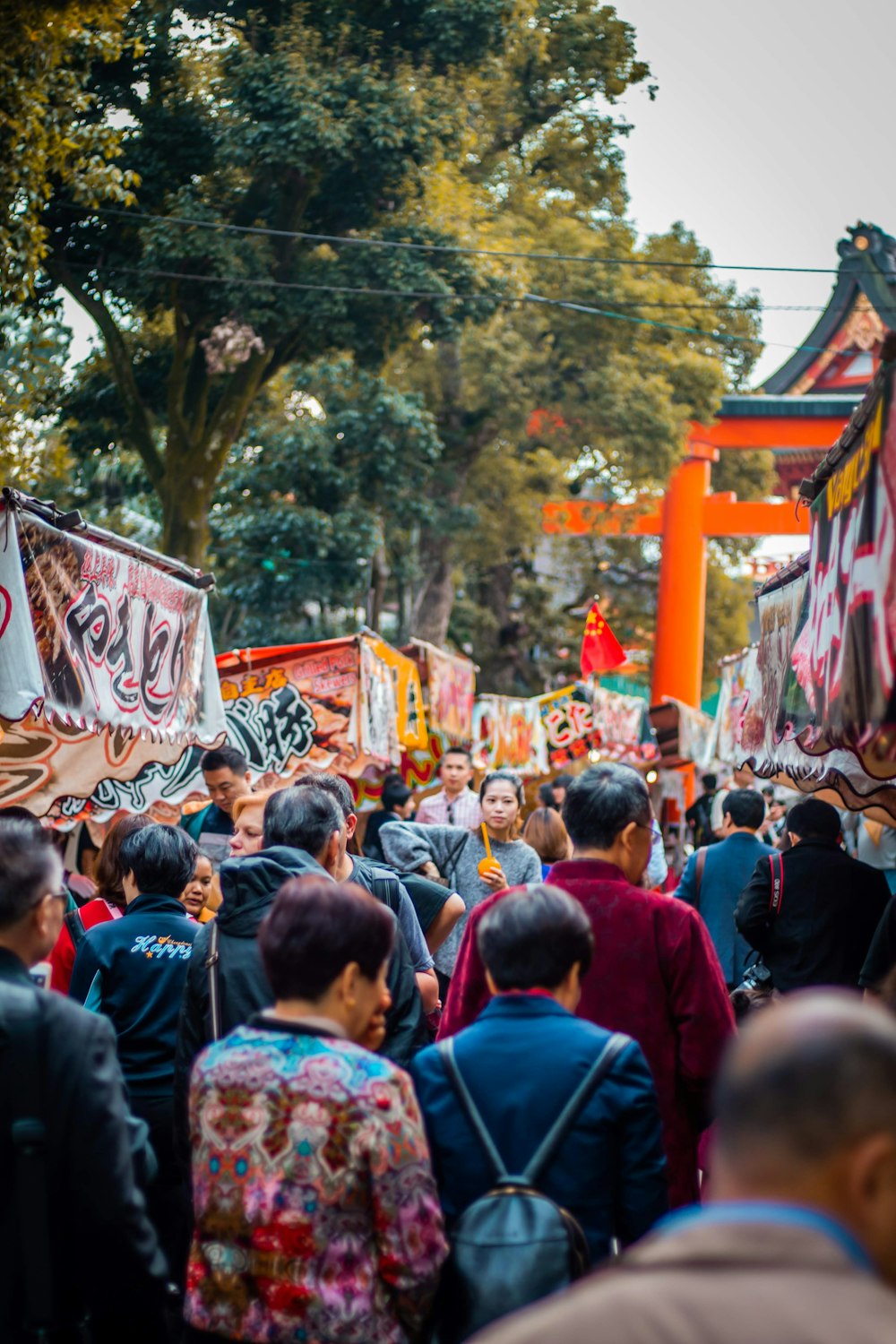 people gathering near green trees during daytime