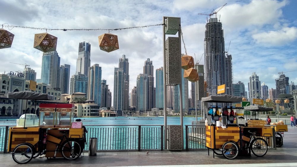 yellow and black auto rickshaw near city buildings during daytime