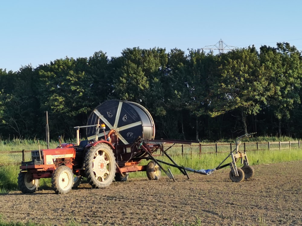 red and white tractor on brown field during daytime