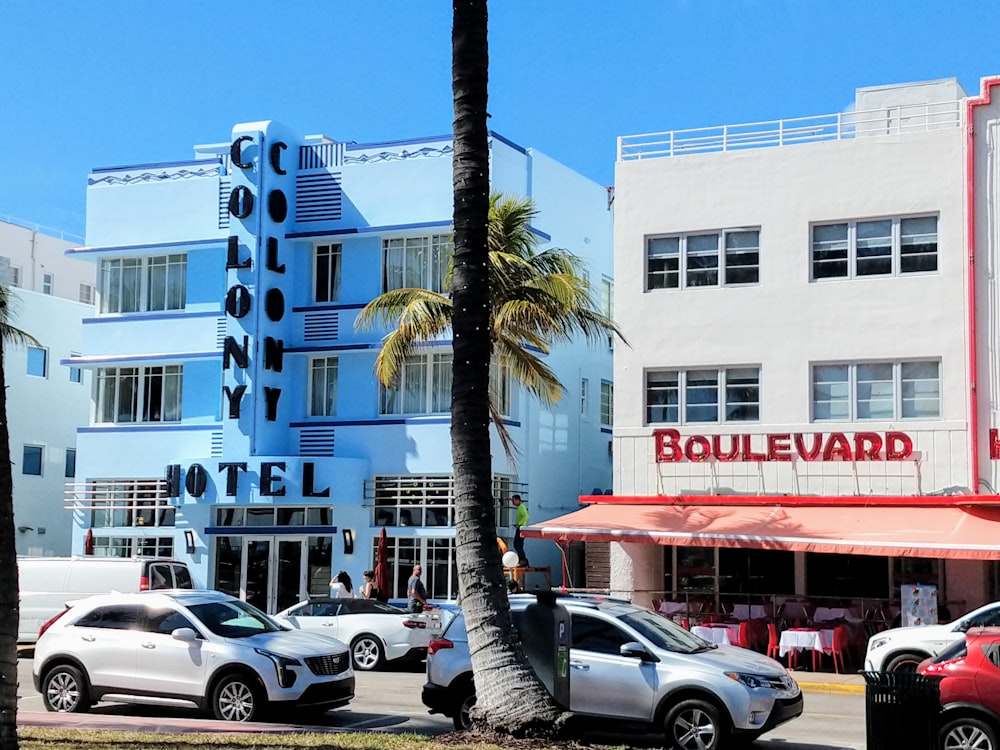 cars parked in front of white concrete building during daytime