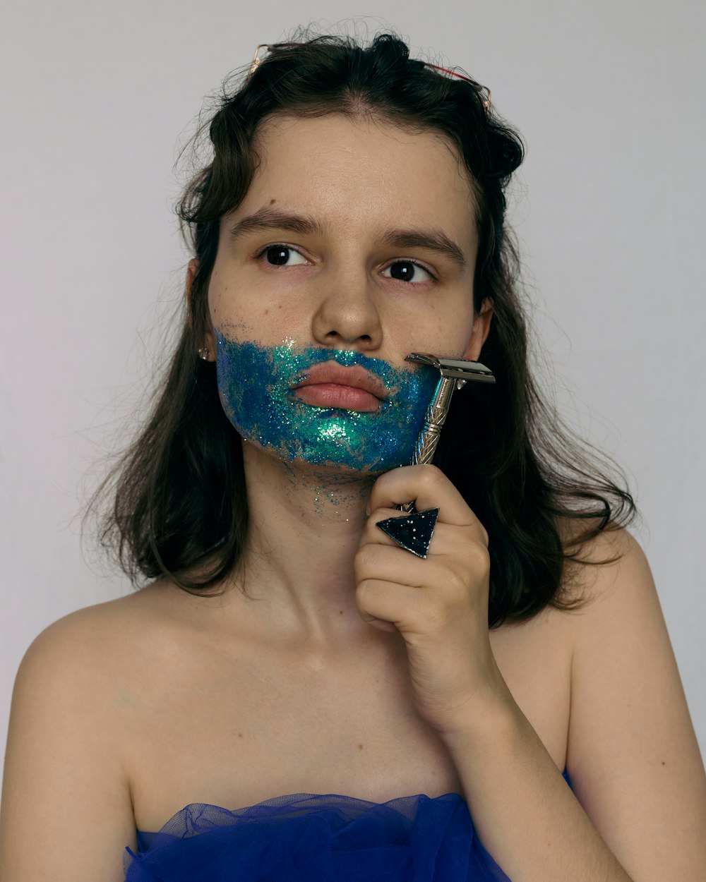 mulher com tinta azul e verde em seu rosto