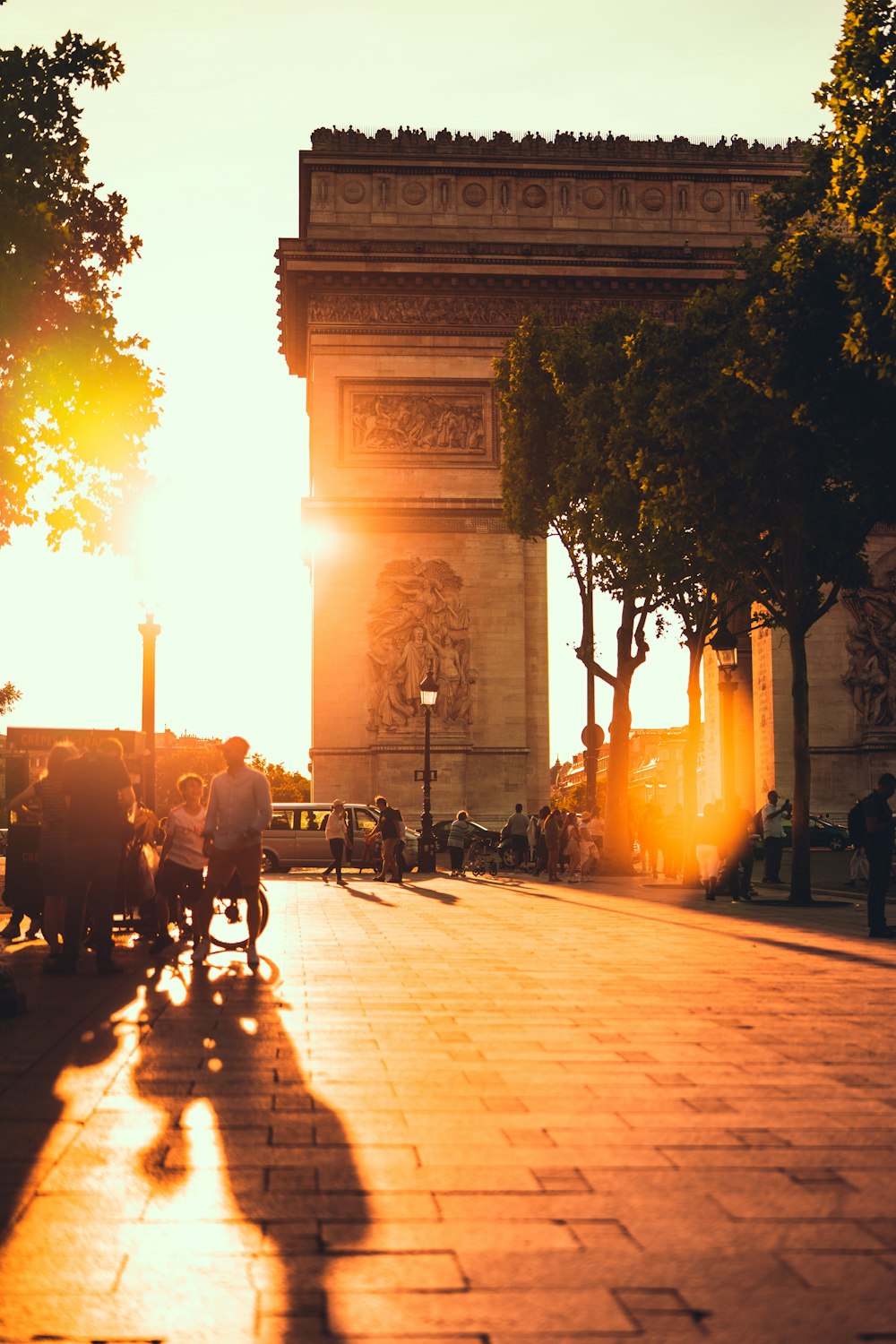 people walking on sidewalk during sunset