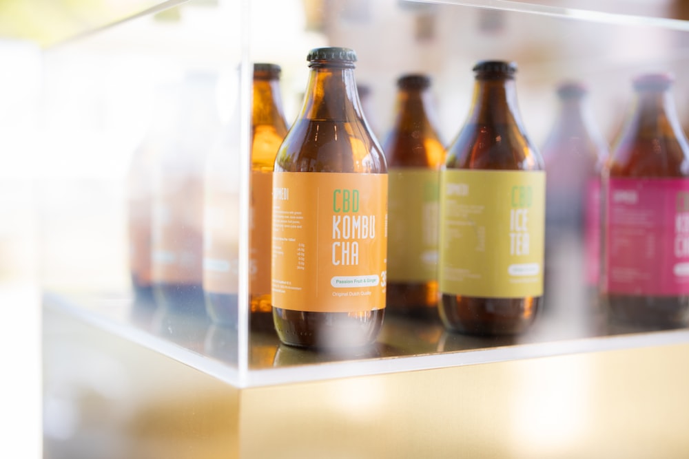 brown glass bottle on white shelf