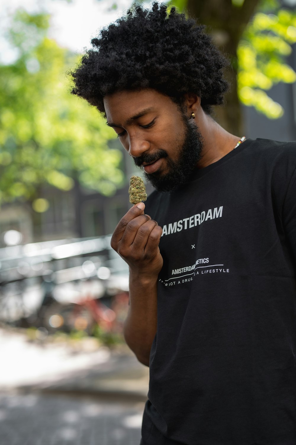 man in black crew neck t-shirt holding gold round coin