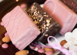 pink and brown chocolate bar on brown wooden round plate