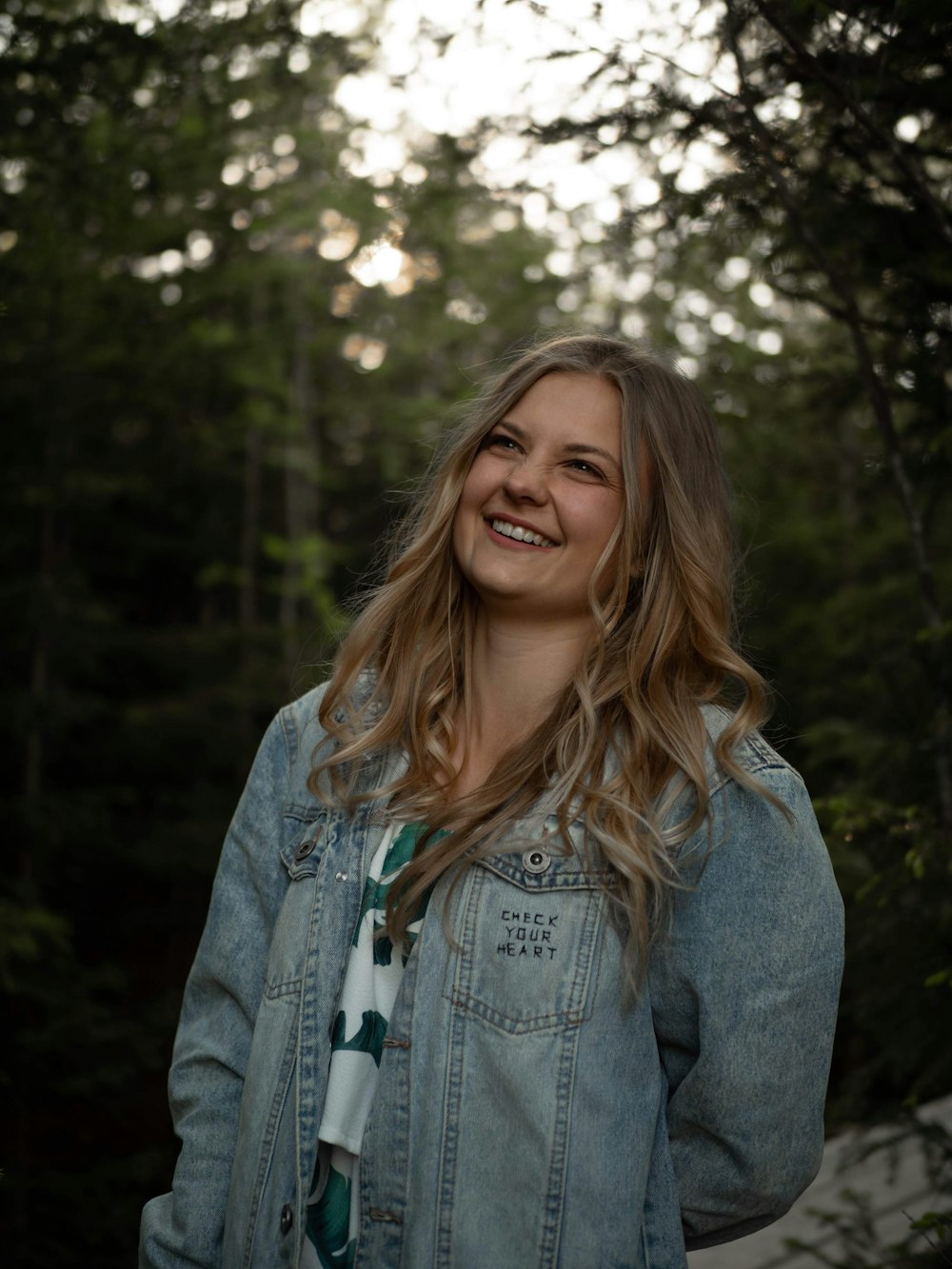 woman in blue denim jacket smiling