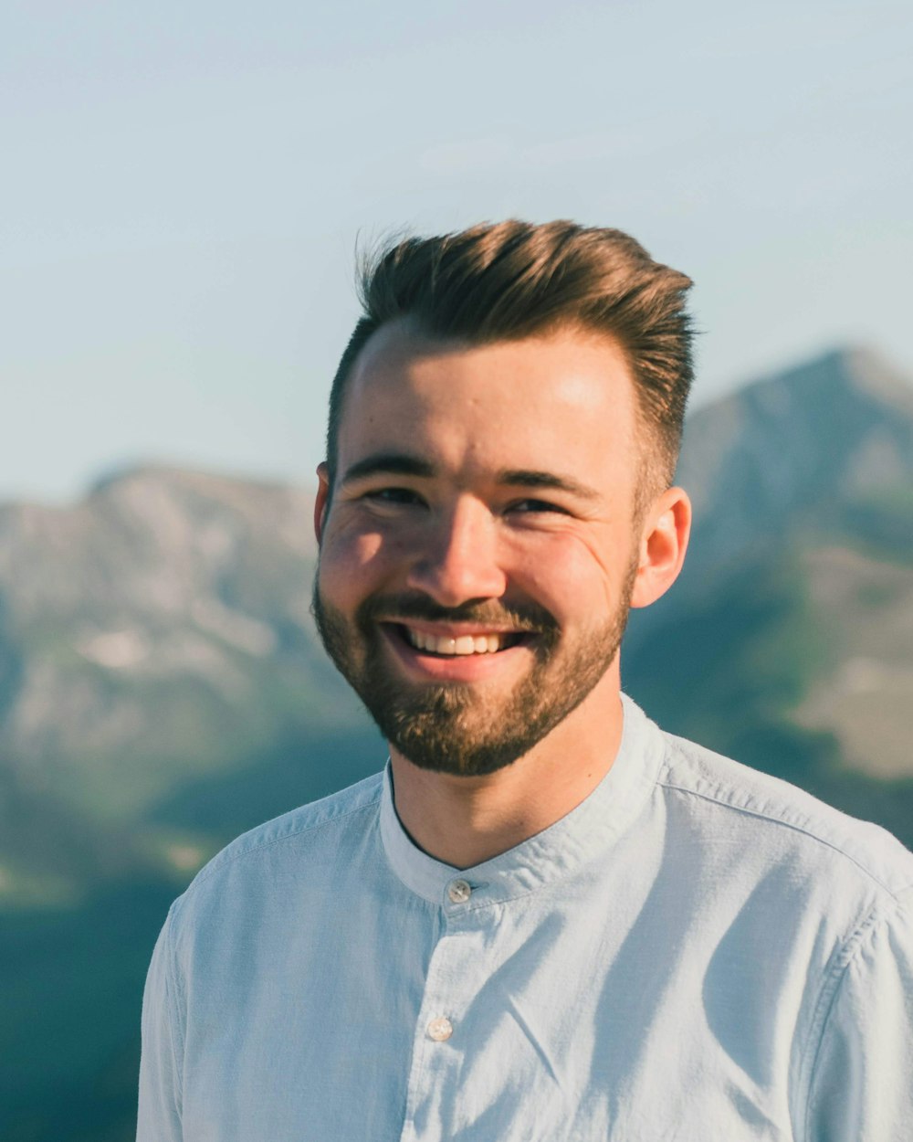 man in white dress shirt smiling