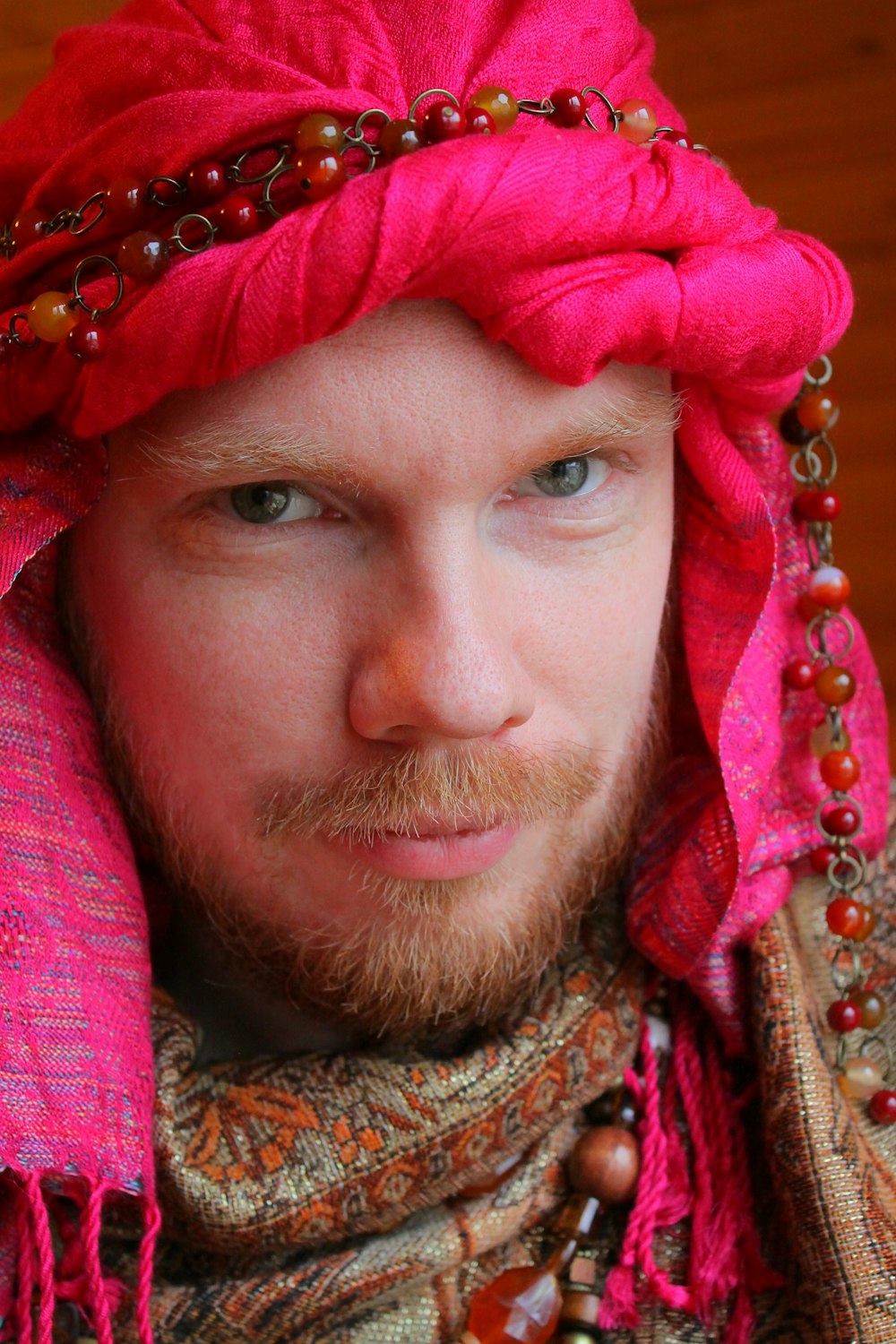 woman in red and gold floral hijab