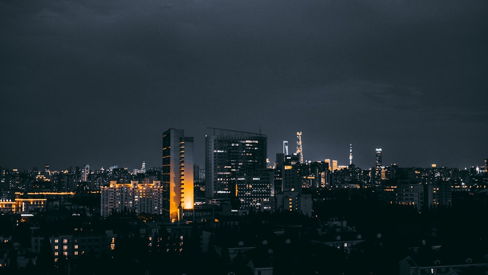 a view of a city at night from the top of a hill