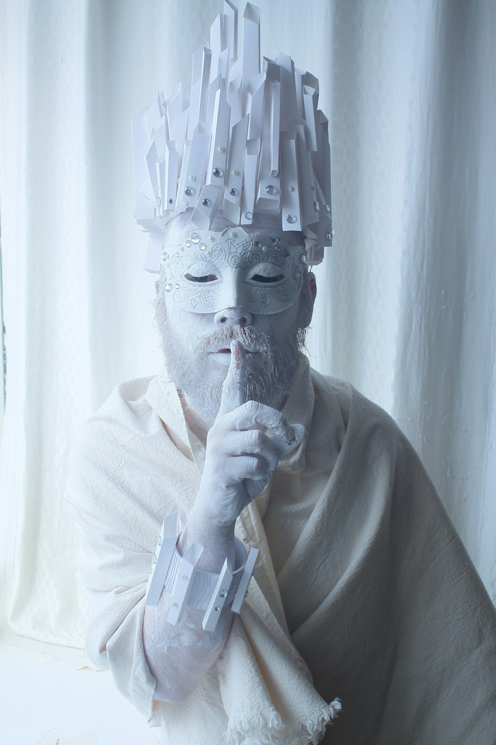 man in white dress shirt wearing gold mask