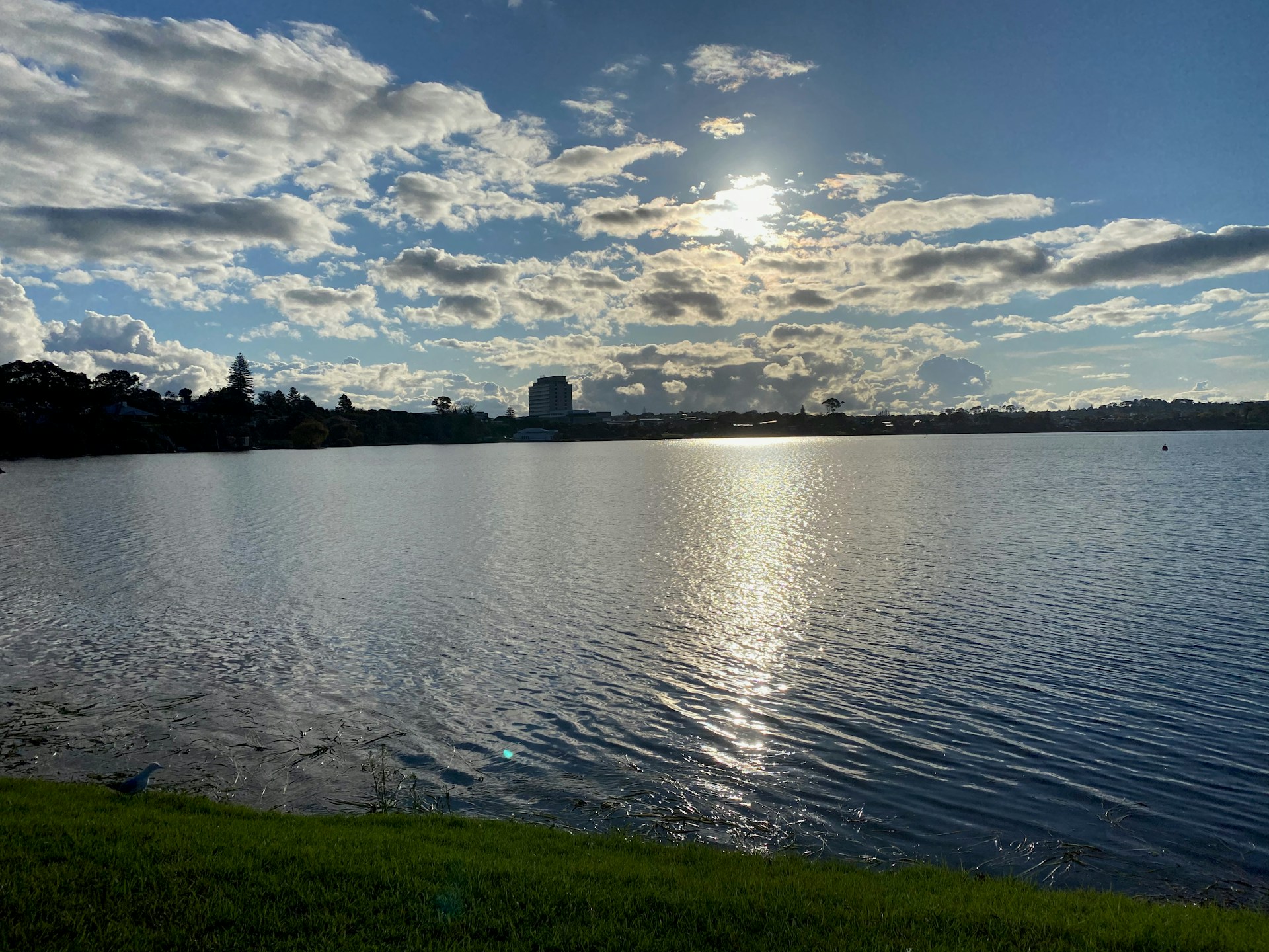A small clickable thumbnail at the bottom showing a calm lake reflecting a bright blue sky with fluffy clouds.