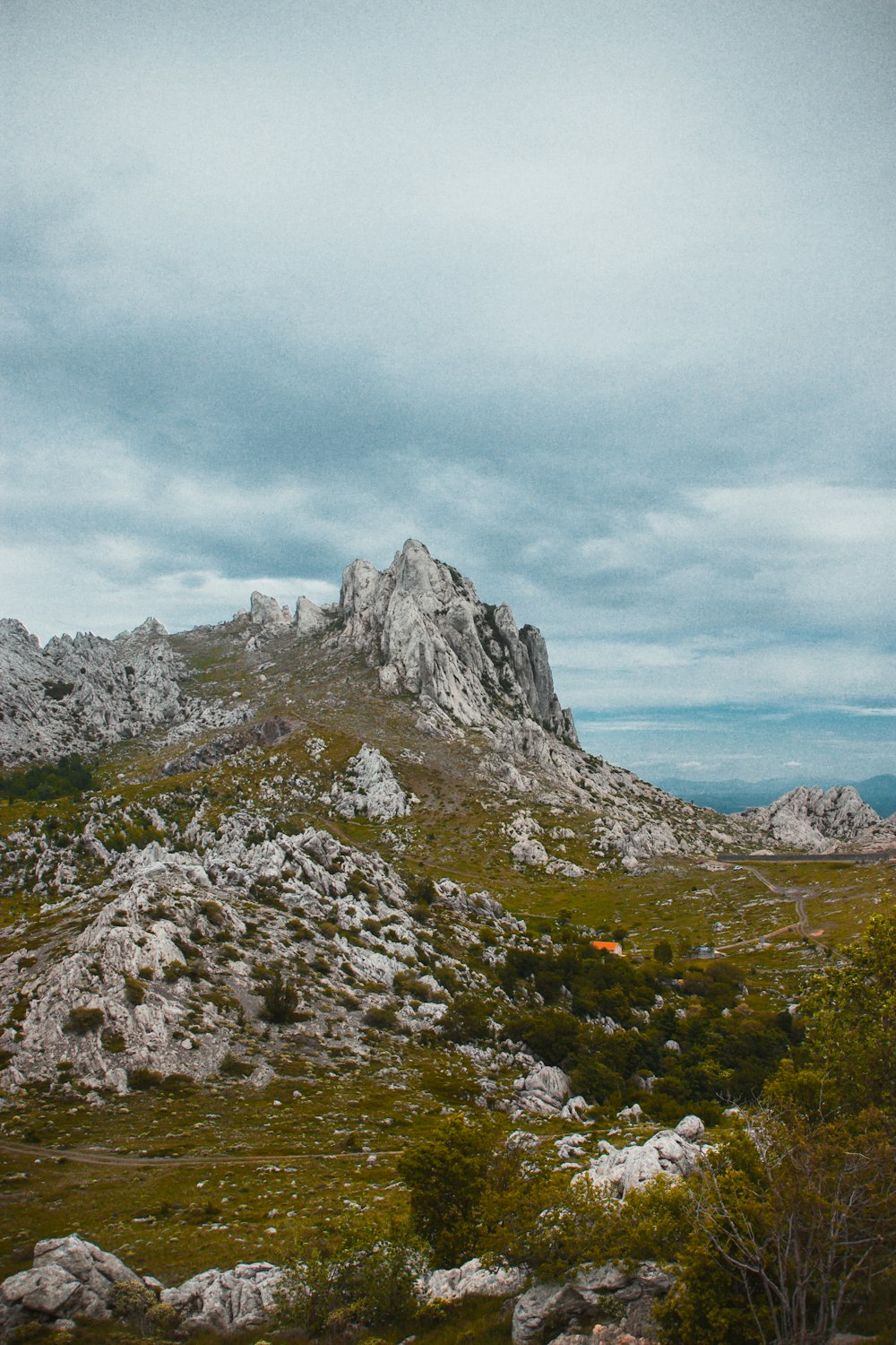 gray rocky mountain under white cloudy sky during daytime