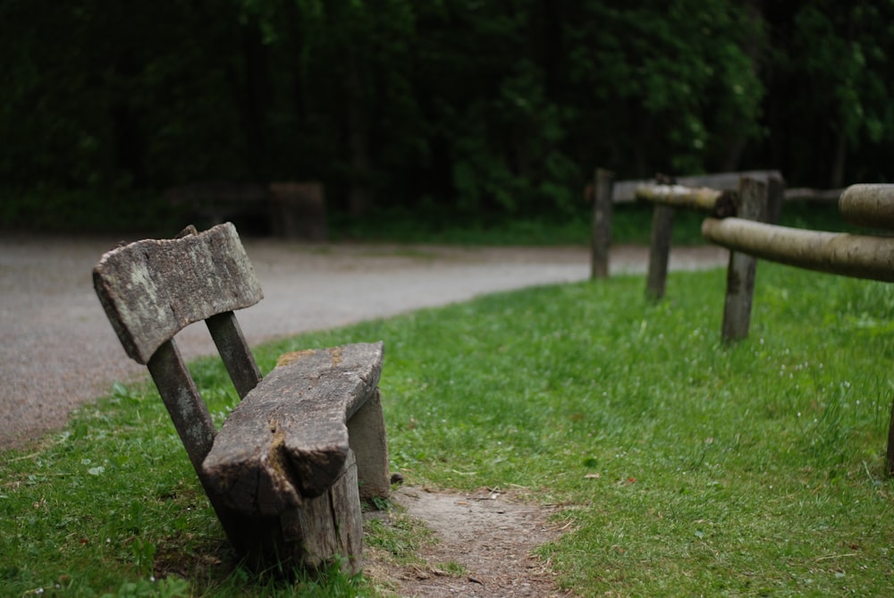 brown wooden bench on green grass field