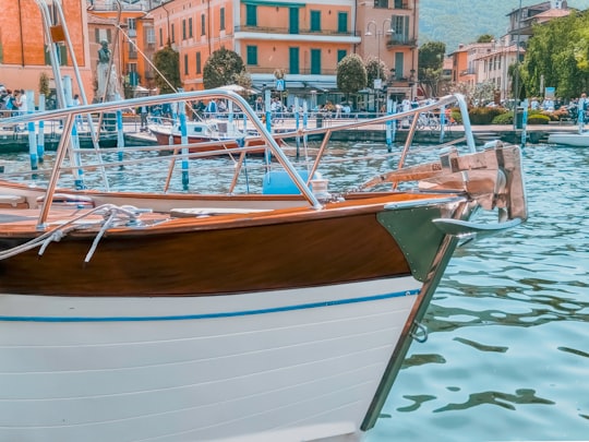 white and brown boat on water in Lake Iseo Italy