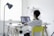 A person using a laptop to shop online in a bright, modern home office.