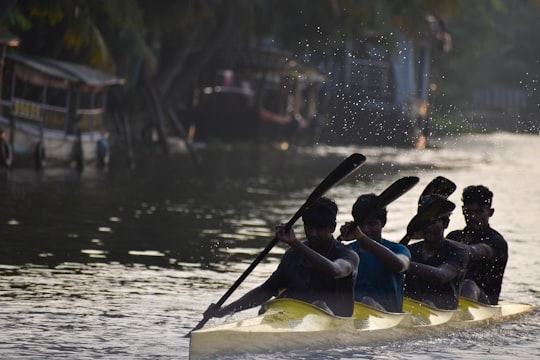 people riding yellow kayak on water during daytime in Alleppey India