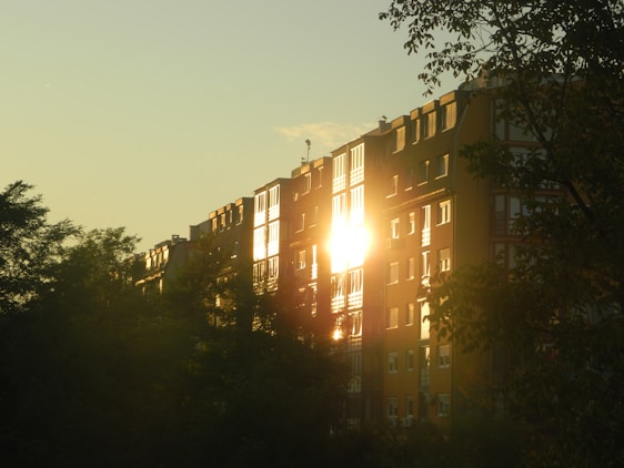 A charming Thai-style apartment building bathed in warm sunset light near Jomtien Beach.