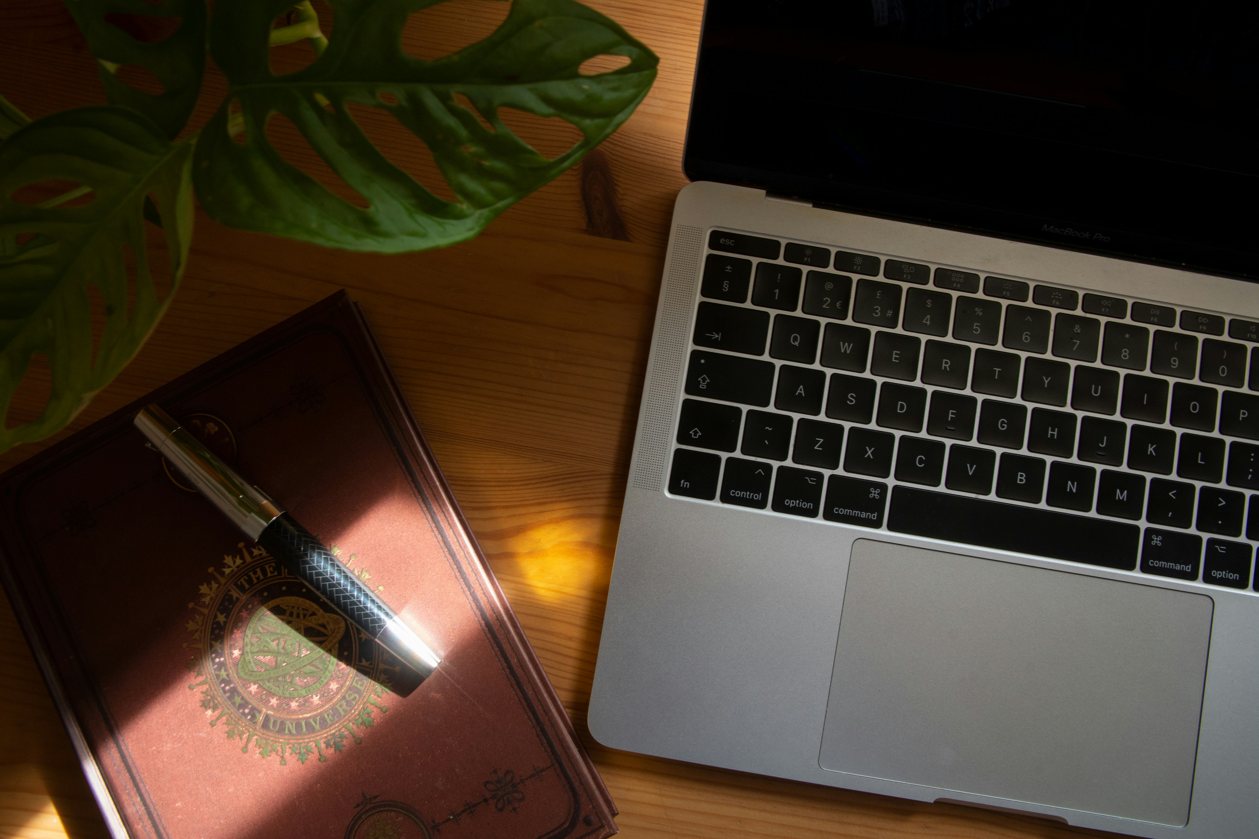macbook pro beside black smartphone