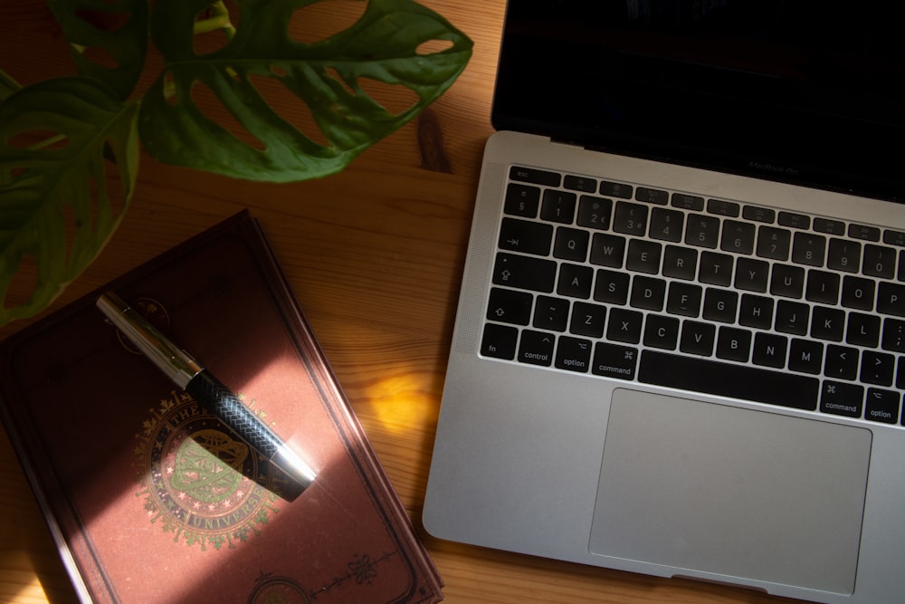 macbook pro beside black smartphone