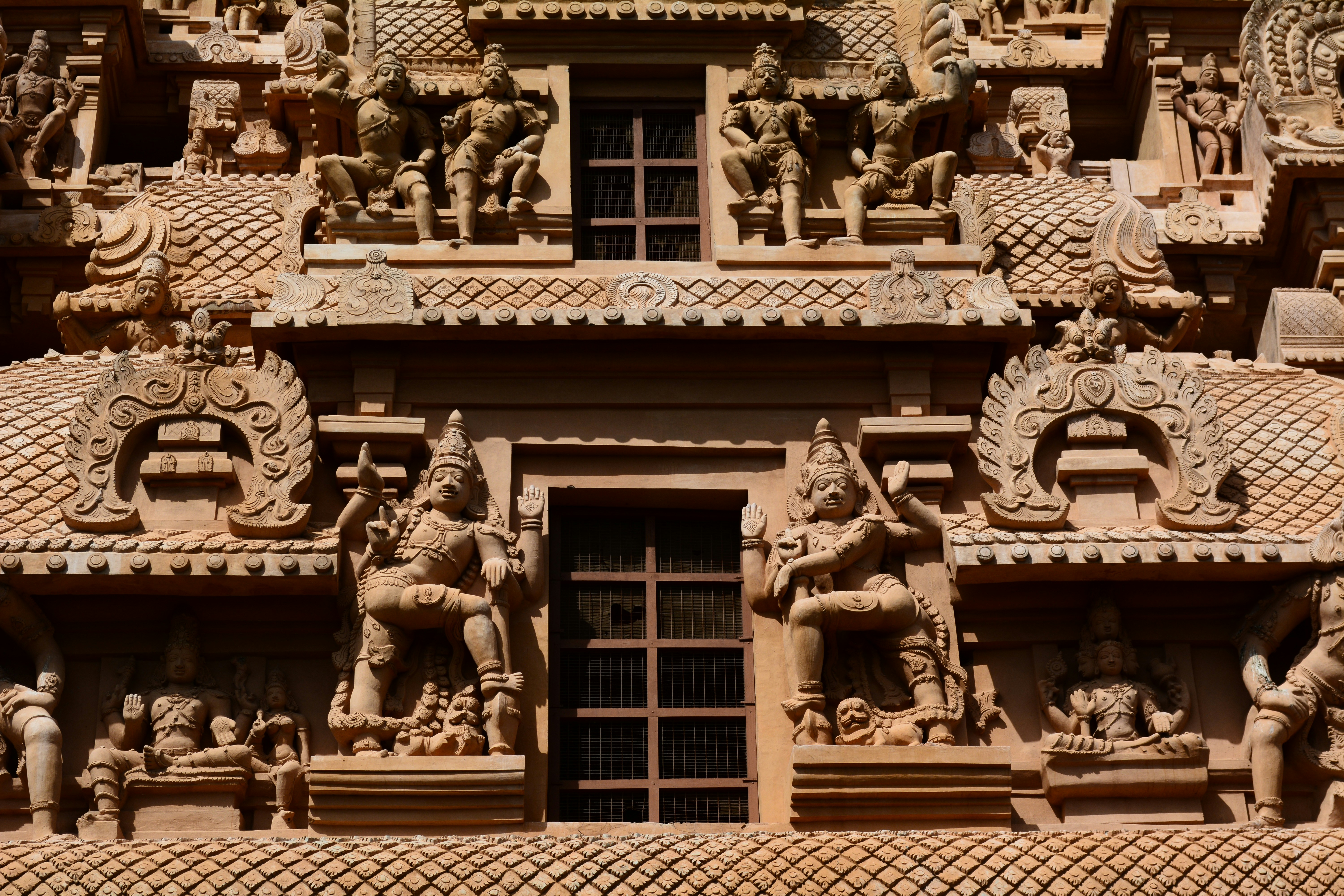 brown concrete statue of man and woman