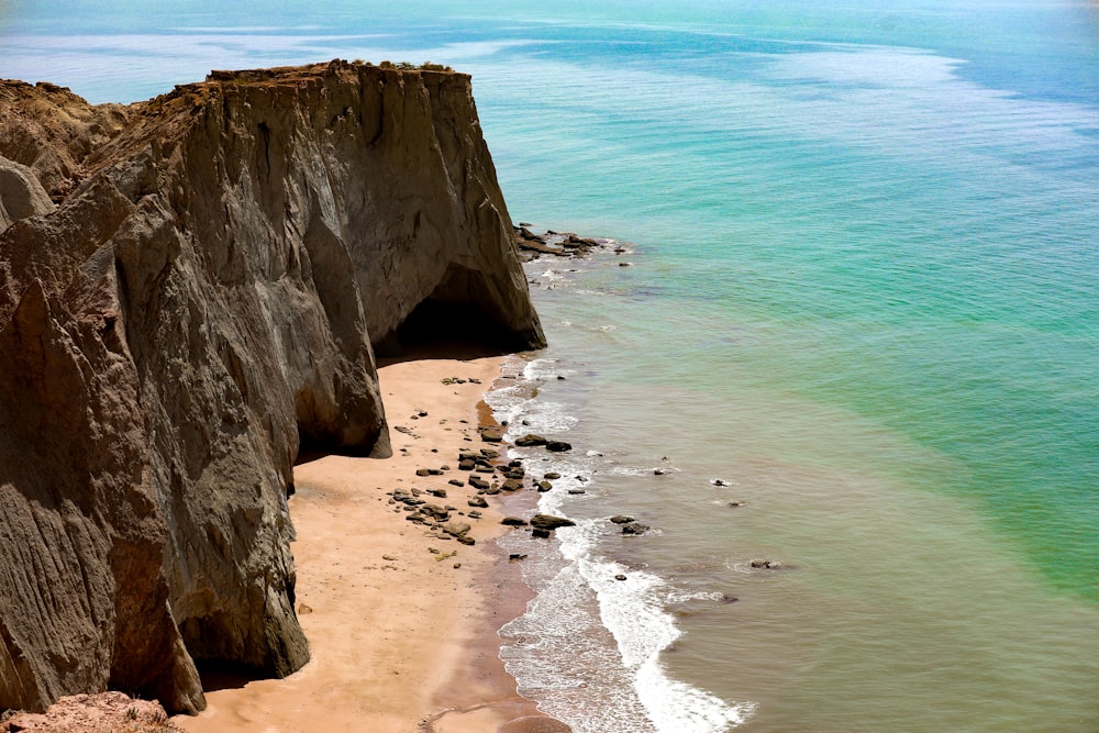 brown rock formation on sea shore during daytime