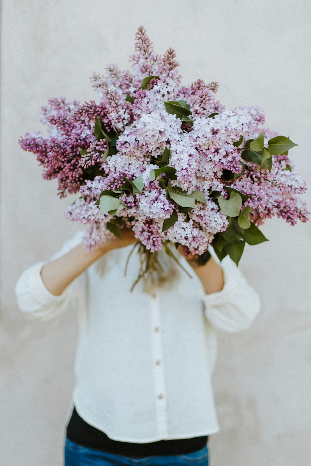 person holding purple flower bouquet