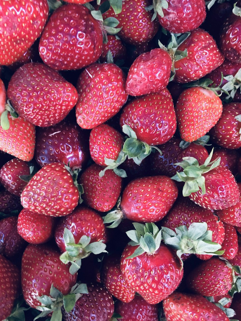 red strawberries on black surface