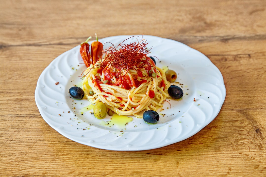 pasta with red sauce on white ceramic plate